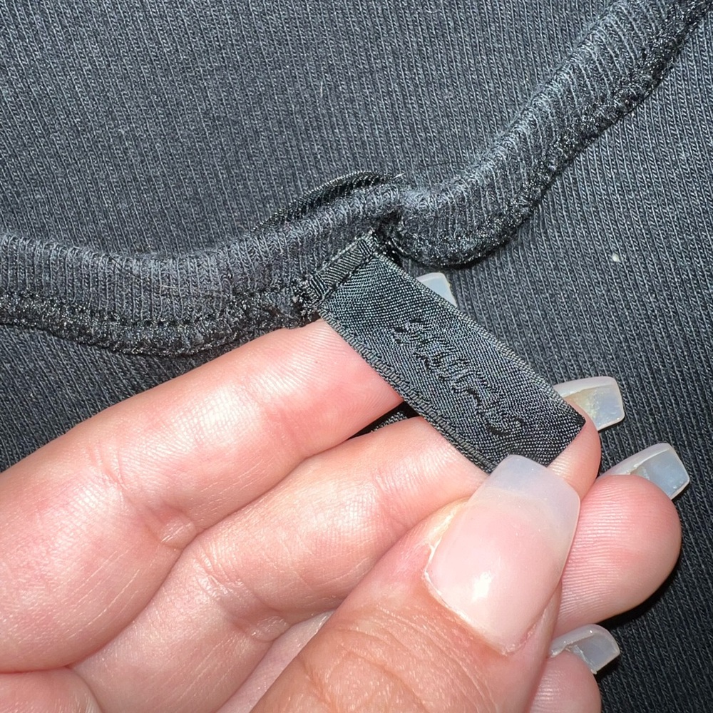 Brand is Skims, size M, black.